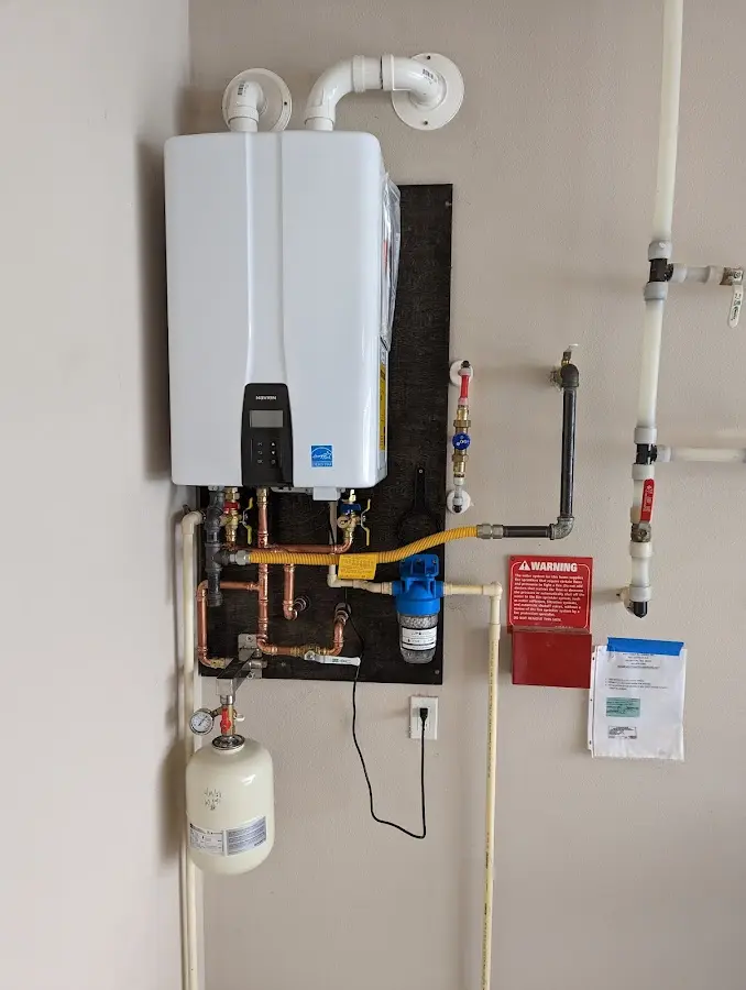 Professional plumber installing copper piping in a Pulaski home